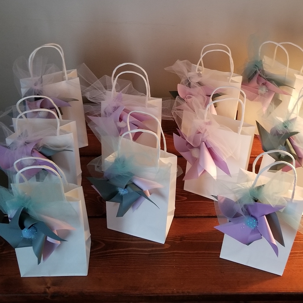 (10) Handmade pinwheels on small white gift bags.